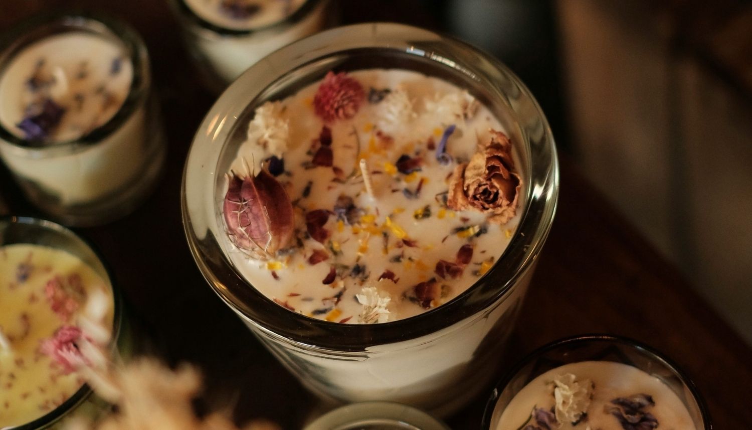 Jar candle with dried flowers sprinkled on top
