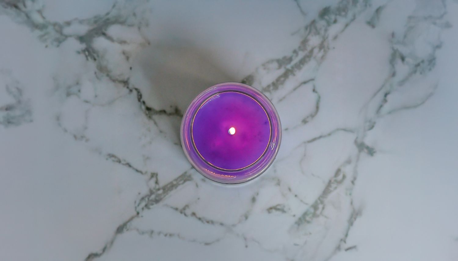 Lit 26-ounce jar on a marble countertop