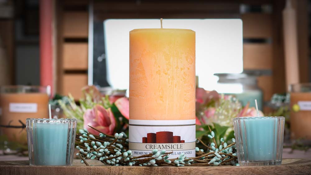 scented candles on a table with blue votives