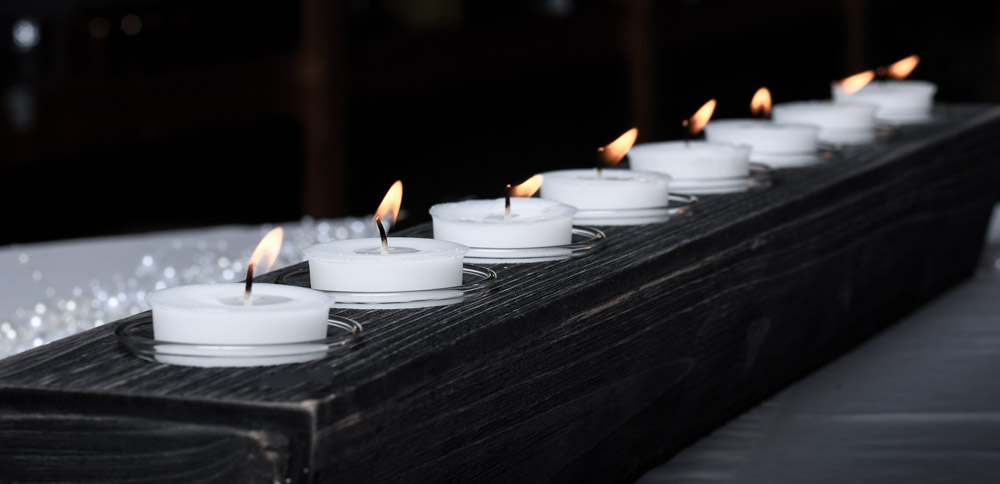 scented votive candles lit in long holder