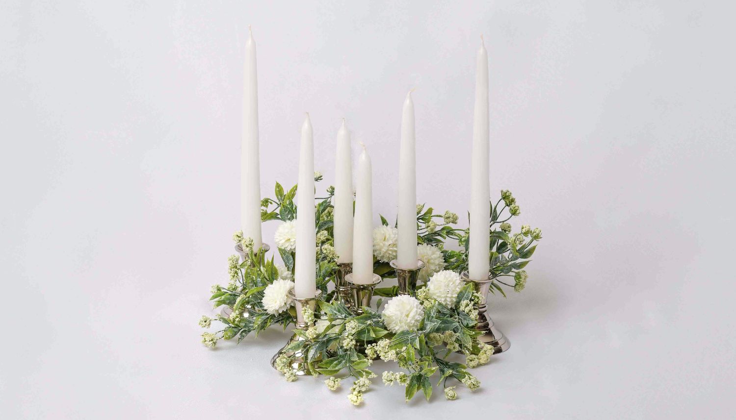 Taper candles in an elegant candle accent ring