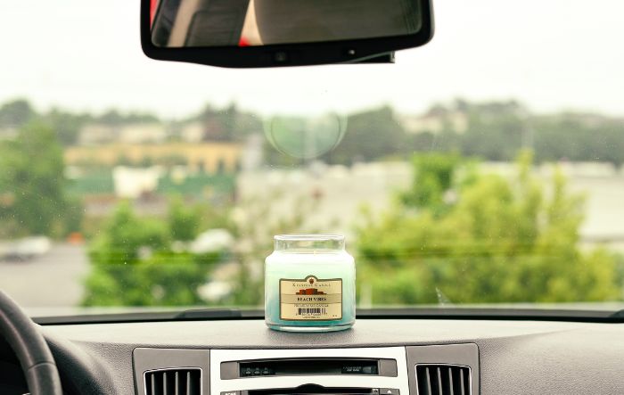 Beach Vibes candle sitting in a warm car