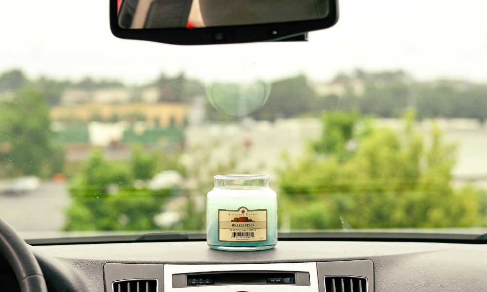 Beach Vibes candle sitting in a warm car