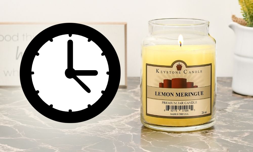 Lit candle next to a clock